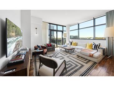 Bright living room with floor to ceiling windows and elegant furniture at 122 N Harrington St # 775, Raleigh, NC 27603