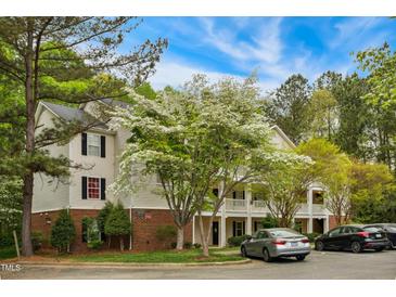 Charming two-story condo building with manicured landscaping and ample parking at 3050 Trailwood Pines Ln # 101, Raleigh, NC 27603
