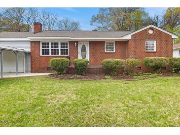 Charming brick home with a well-manicured front yard and inviting curb appeal at 324 Dare St, Burlington, NC 27217