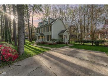 Charming two-story home featuring dormer windows, black shutters, and lush green lawn, providing great curb appeal at 4217 Pike Rd, Raleigh, NC 27613