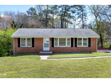 Charming brick home with a well-maintained lawn and traditional black shutters enhancing its curb appeal at 4308 James Rd, Raleigh, NC 27616