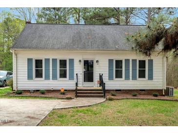 Charming single story home featuring blue shutters and landscaped front yard at 5578 Tabbs Creek Church Rd, Oxford, NC 27565
