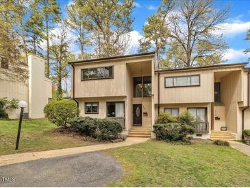 Traditional home with a beautiful lawn, mature trees, and a charming entryway at 717 E Millbrook Rd, Raleigh, NC 27609