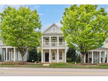 Charming two-story home with a double balcony and a well-maintained lawn and two mature trees at 7819 Acc Blvd, Raleigh, NC 27612