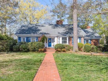 Charming brick home with blue shutters, well-manicured lawn, and a welcoming brick walkway at 806 S First St, Smithfield, NC 27577