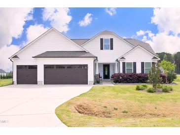 Charming two-story home with a manicured lawn, two-car garage, and inviting front porch, perfect for curb appeal at 127 Hurricane Aly, Benson, NC 27504