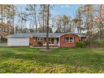 Charming brick home with inviting front porch and well-maintained lawn in a treed neighborhood at 209 High House Rd, Cary, NC 27513