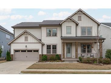 Charming two-story home with a covered front porch and an attached two-car garage at 288 Whispering Wind Dr, Chapel Hill, NC 27516