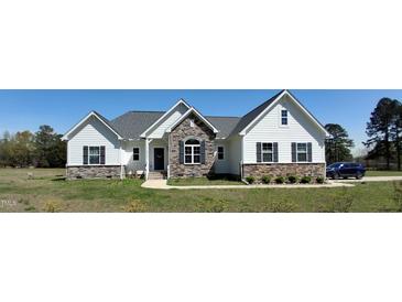 Charming new construction home featuring stone accents, a gray roof, and a well-manicured lawn at 2915 Cox Mill Rd, Sanford, NC 27332