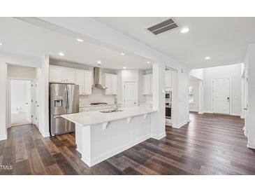 Modern kitchen with stainless steel appliances, white cabinets, and an island at 3348 Table Mountain Pine Dr, Raleigh, NC 27616