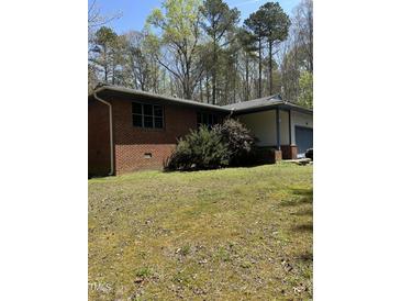 Charming one-story brick home with well-maintained lawn and attached garage at 4001 W Antioch Dr, Oxford, NC 27565
