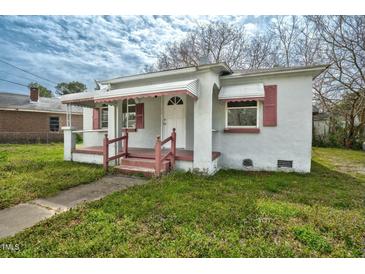Charming one-story home with a covered porch and red and white awnings at 415 Estell St, Rocky Mount, NC 27803