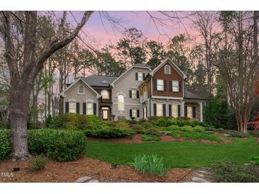 Stately two-story home featuring lush landscaping, stone accents, and a welcoming front entrance at 506 Rose Point Dr, Cary, NC 27518