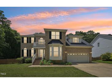 Beautiful two-story brick home with manicured lawn and attached two-car garage at 5144 Pinehall Wynd, Raleigh, NC 27604