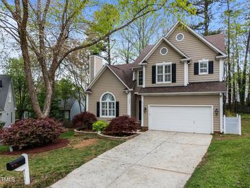 Charming two-story home with a well-manicured lawn, featuring a two-car garage and neutral-colored siding at 5301 Tilford Ln, Raleigh, NC 27613