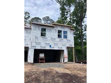 Two-story home under construction with Tyvek wrap and windows installed at 6960 Doddridge Ln # 15, Cary, NC 27519