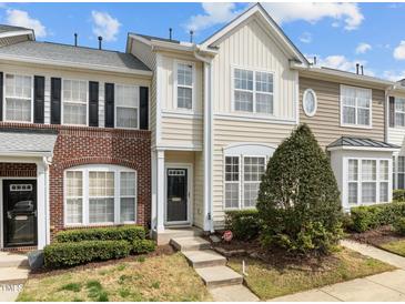Charming townhouse with mixed brick and siding, complemented by landscaped bushes at 7628 Winners Edge St, Raleigh, NC 27617