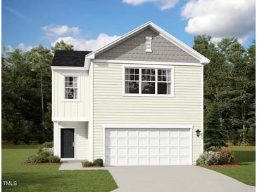 Charming two-story home with a white garage door, light yellow siding and a black front door at 1173 Solace Way, Rolesville, NC 27571
