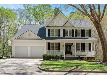 Charming two-story traditional home featuring a welcoming front porch and attached two car garage at 118 Benedum Pl, Cary, NC 27518