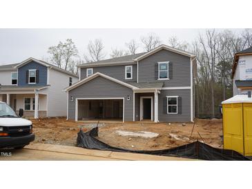 Two-story home with gray siding, an attached two-car garage, and manicured front lawn at 2124 Cherry Creek Rd, Haw River, NC 27258