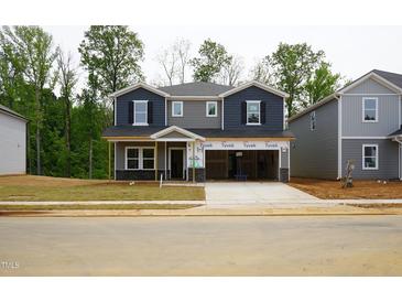 New two-story home featuring a gray exterior, two car garage and a well-manicured lawn at 2202 Cherry Creek Rd, Haw River, NC 27258