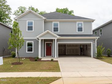 New construction two-story home featuring gray siding, a red front door, and an attached two-car garage at 2206 Cherry Creek Rd, Haw River, NC 27258