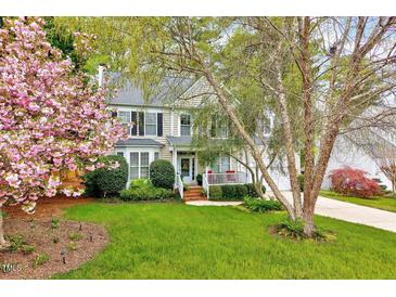 Charming two-story home with well-manicured lawn and flowering trees at 2208 Walden Creek Dr, Apex, NC 27523