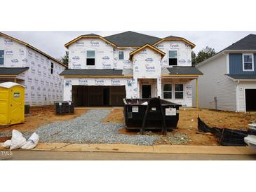 New home construction with Tyvek wrap and dumpster ready for further building at 2211 Cherry Creek Rd, Haw River, NC 27258