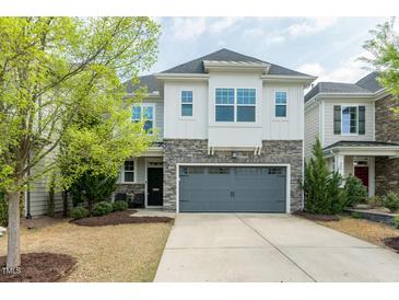 Inviting two-story home featuring a grey two-car garage and stone accents on the facade at 237 Begen St, Morrisville, NC 27560