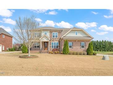 Beautiful two-story brick home featuring a manicured lawn and detailed architectural design at 2936 Turning Brook Ln, Raleigh, NC 27616