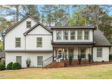 Beautiful home with white brick and siding, gray trim, and a welcoming front porch at 302 Rutherglen Dr, Cary, NC 27511