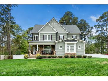 Beautiful two-story home featuring a covered porch, stone accents, and well-manicured lawn at 321 Third Ave, Knightdale, NC 27545