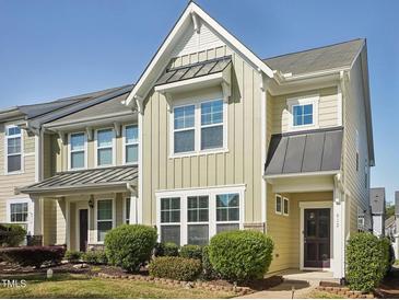 Charming townhome with manicured landscaping, a covered entrance, and a blend of modern and traditional design elements at 912 Ambergate Sta, Apex, NC 27502