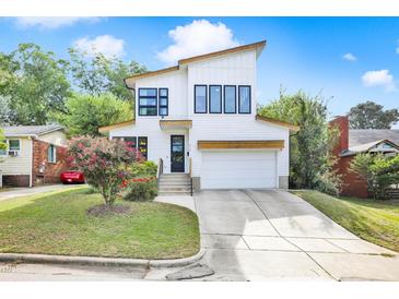 Charming two-story home featuring modern architectural design, landscaped yard, and inviting curb appeal at 915 S State St, Raleigh, NC 27601