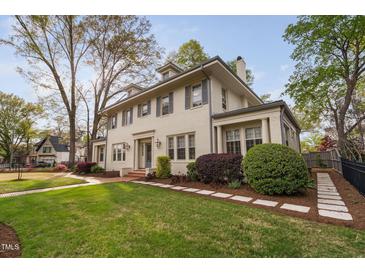 Charming home featuring a well-maintained lawn and lush landscaping at 1403 Wake Forest Rd, Raleigh, NC 27604
