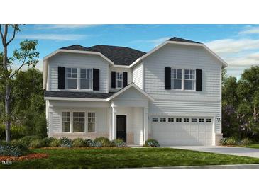 Charming two-story home featuring a manicured lawn, attached garage, and classic architectural details at 2605 Stonington Dr, Cary, NC 27523