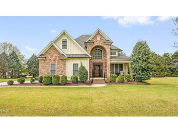 Beautiful two-story home featuring stone and vinyl siding, manicured landscaping, and a welcoming front entrance at 432 Kings Hollow Dr, Raleigh, NC 27603
