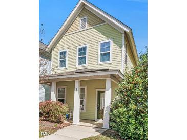 Charming two-story home with a covered front porch, lush greenery, and a well-maintained lawn at 45 Summersweet Ln, Chapel Hill, NC 27516