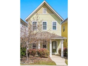 Charming two-story home with a cozy front porch and lush landscaping at 45 Summersweet Ln, Chapel Hill, NC 27516