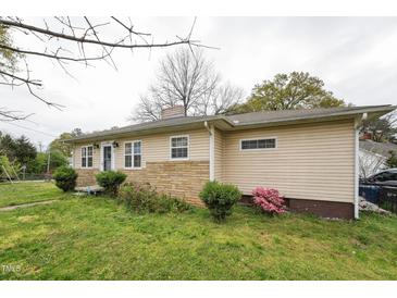 Charming single-story home featuring vinyl siding and a stone accent wall at 518 N Gutherie Ave, Durham, NC 27703