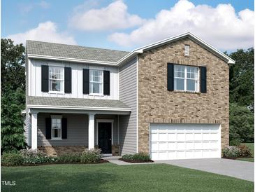 Charming two-story home featuring brick and siding with a well-manicured lawn at 841 Kenyon Spring Dr, Zebulon, NC 27597