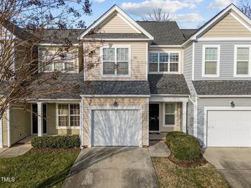 Charming two-story townhome featuring a one car garage and traditional architectural details at 10133 Bessborough Dr, Raleigh, NC 27617