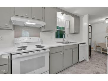 Bright kitchen features white appliances, gray cabinets, and updated counters at 1332 Stallings Rd, Chapel Hill, NC 27516