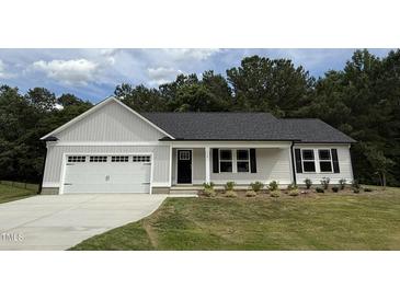 Charming single-story home with a gray exterior, attached garage, and well-manicured front lawn at 170 Eason Creek Way, Clayton, NC 27527