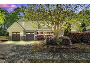 Charming two-story home featuring a well-manicured lawn, mature tree, and inviting curb appeal with a two car garage at 181 Fawn Hill Ct, Garner, NC 27529