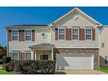 Charming two-story home featuring brown shutters, stone accents and a white garage door at 2321 Stony Bottom Dr, Raleigh, NC 27610