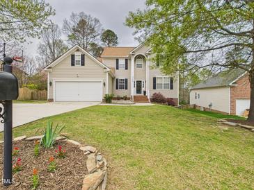 Charming two-story home features a well-maintained lawn, attached garage, and inviting front entrance at 3705 Andoversford Ct, Wake Forest, NC 27587