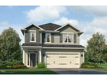 Charming two-story home with a two-car garage, attractive landscaping, and classic architectural details at 384 Hopewell Branch Ct, Smithfield, NC 27577