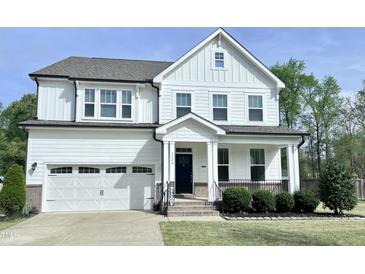 Beautiful two-story home with white siding, attached garage, and manicured lawn at 3908 Bostwyck Dr, Fuquay Varina, NC 27526