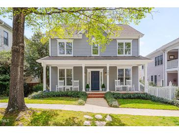 Charming two-story home with gray siding, white trim, covered front porch, and inviting curb appeal at 507 Parkside Cir, Chapel Hill, NC 27516